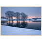 Frosted trees reflected in a frozen lake at first light, print in a natural wood frame