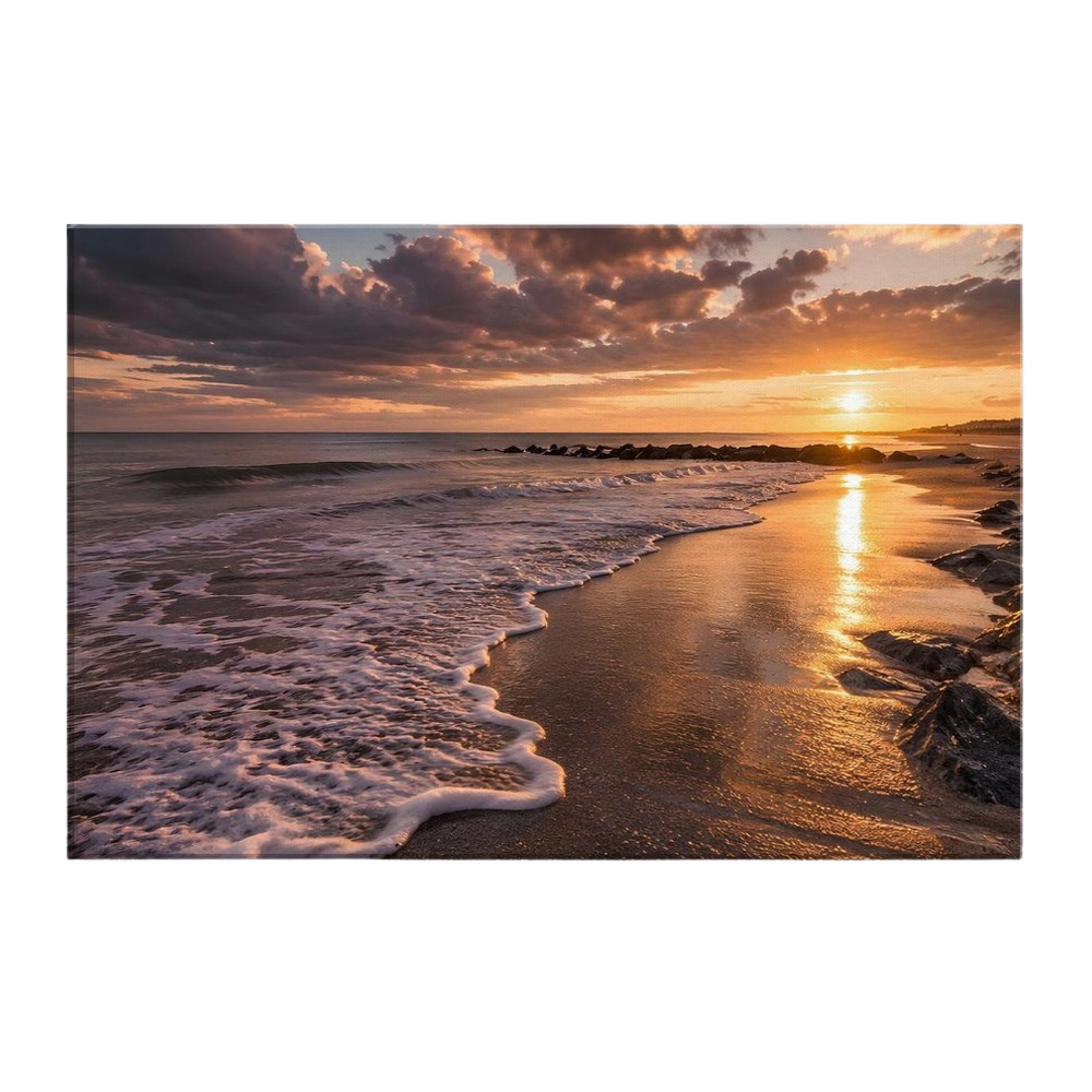 A low sun over a quiet shoreline with a long column of gold across wet sand, foam curving up the beach and a dark rock groyne to the right, printed on stretched canvas
