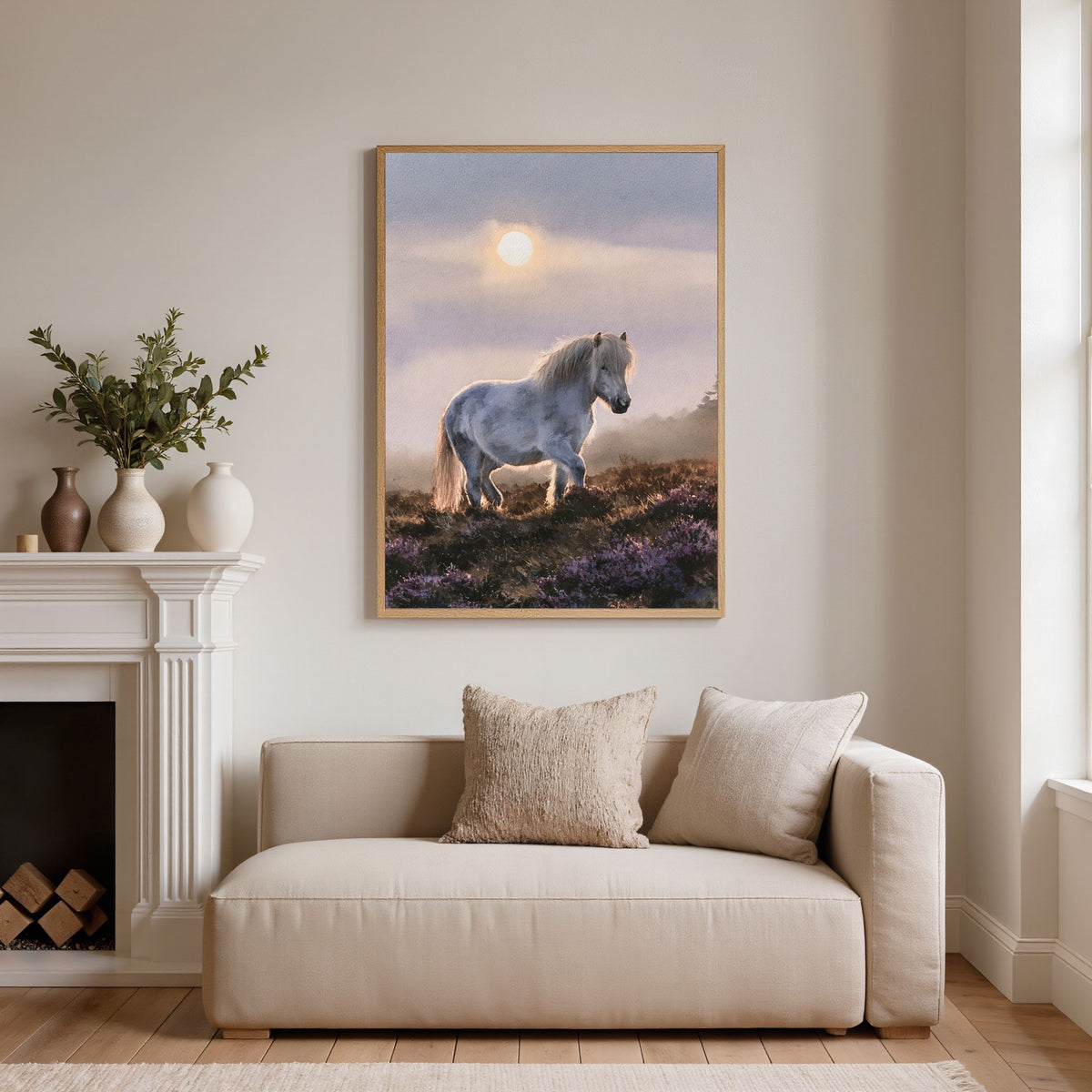 Grey pony on the heather, in a natural wood frame on a cream wall above a linen sofa beside a white fireplace in a living room