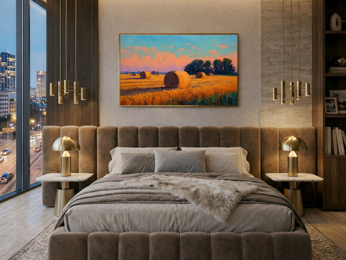 Impressionist harvest field of hay bales at sunset, framed in light wood above a velvet bed in a city apartment bedroom