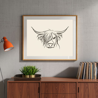 Minimal line drawing of a Highland cow, in a light wood frame above a walnut sideboard with a plant and vinyl in a living room
