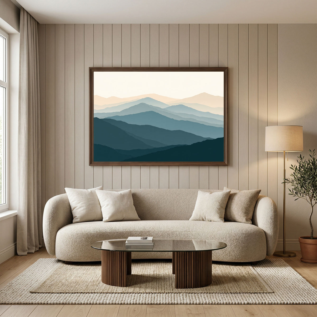 Highland ridgelines in layered flat bands, in a pale wood frame above a cream boucle sofa in a neutral living room