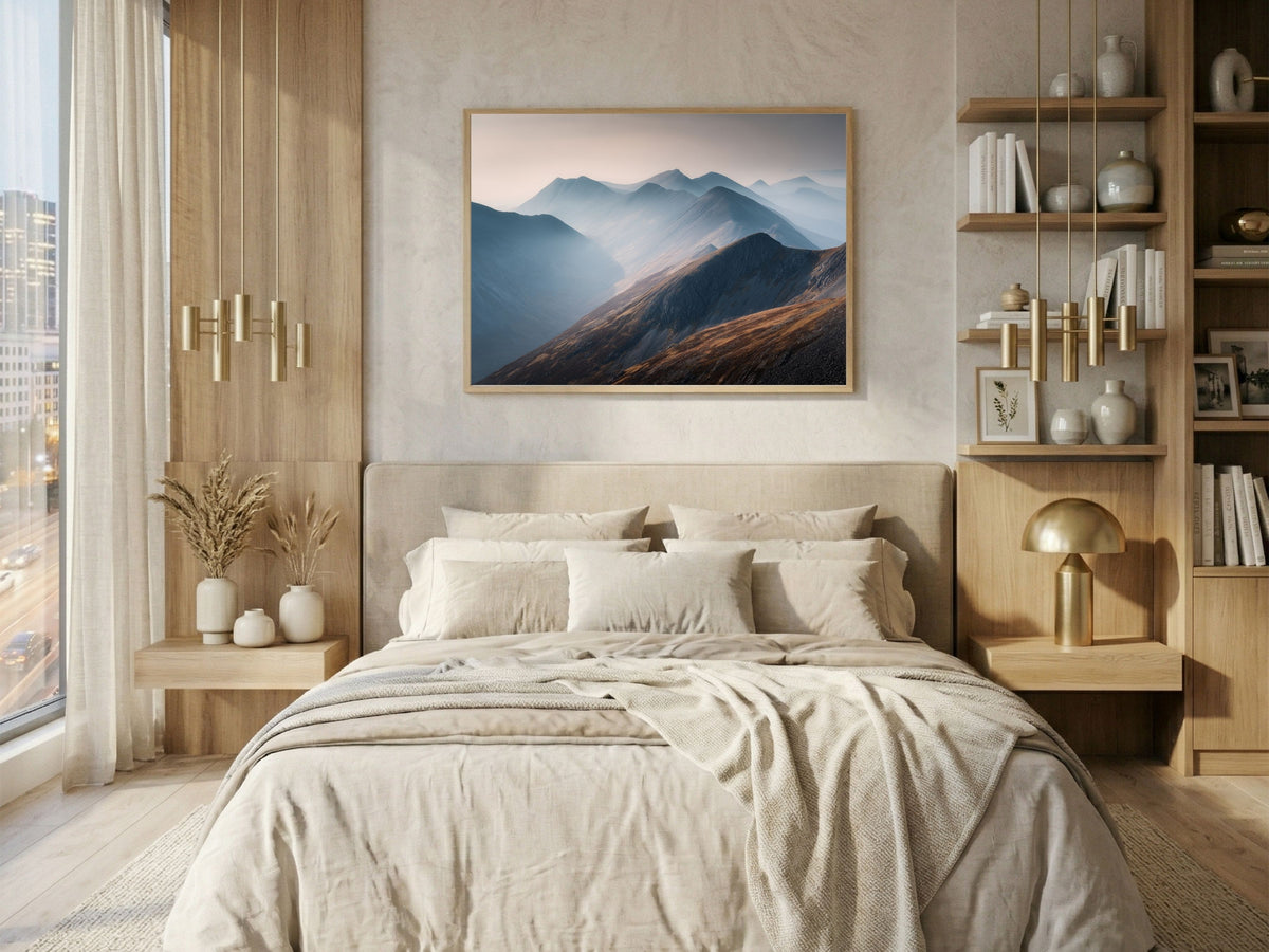 Layered Highland ridges in morning mist, framed in light wood above a bed in a bright city bedroom