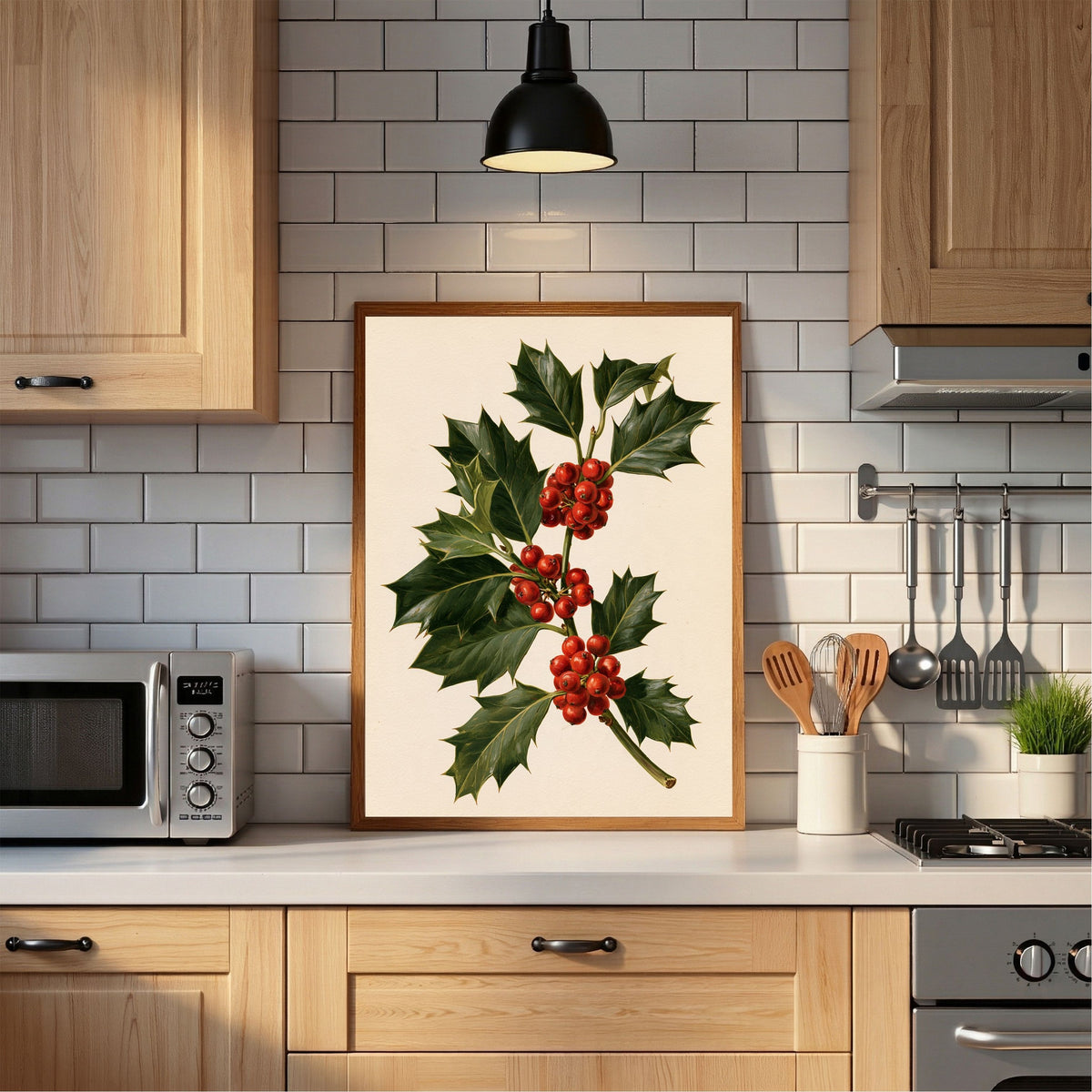 Holly sprig with red berries, in a light wood frame propped on a worktop in a bright tiled kitchen