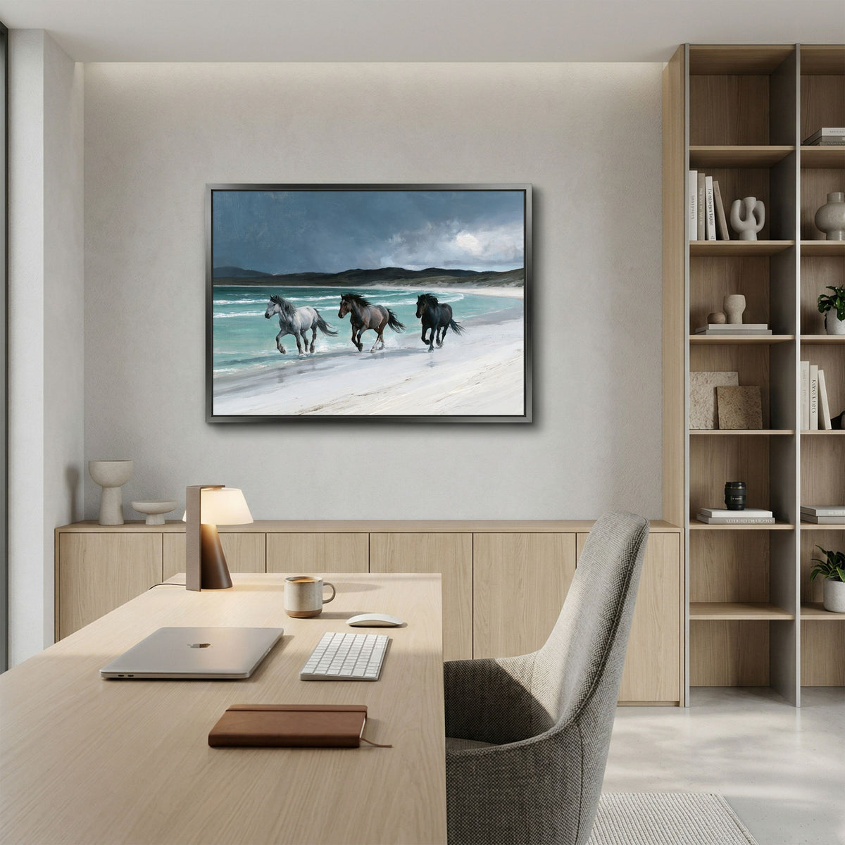 Horses on a Hebridean beach, in a slim grey frame above a pale oak desk and shelving in a home office