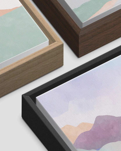 The three framed canvas options available: natural wood, dark wood and black, shown at the corner with the canvas set proud inside the frame