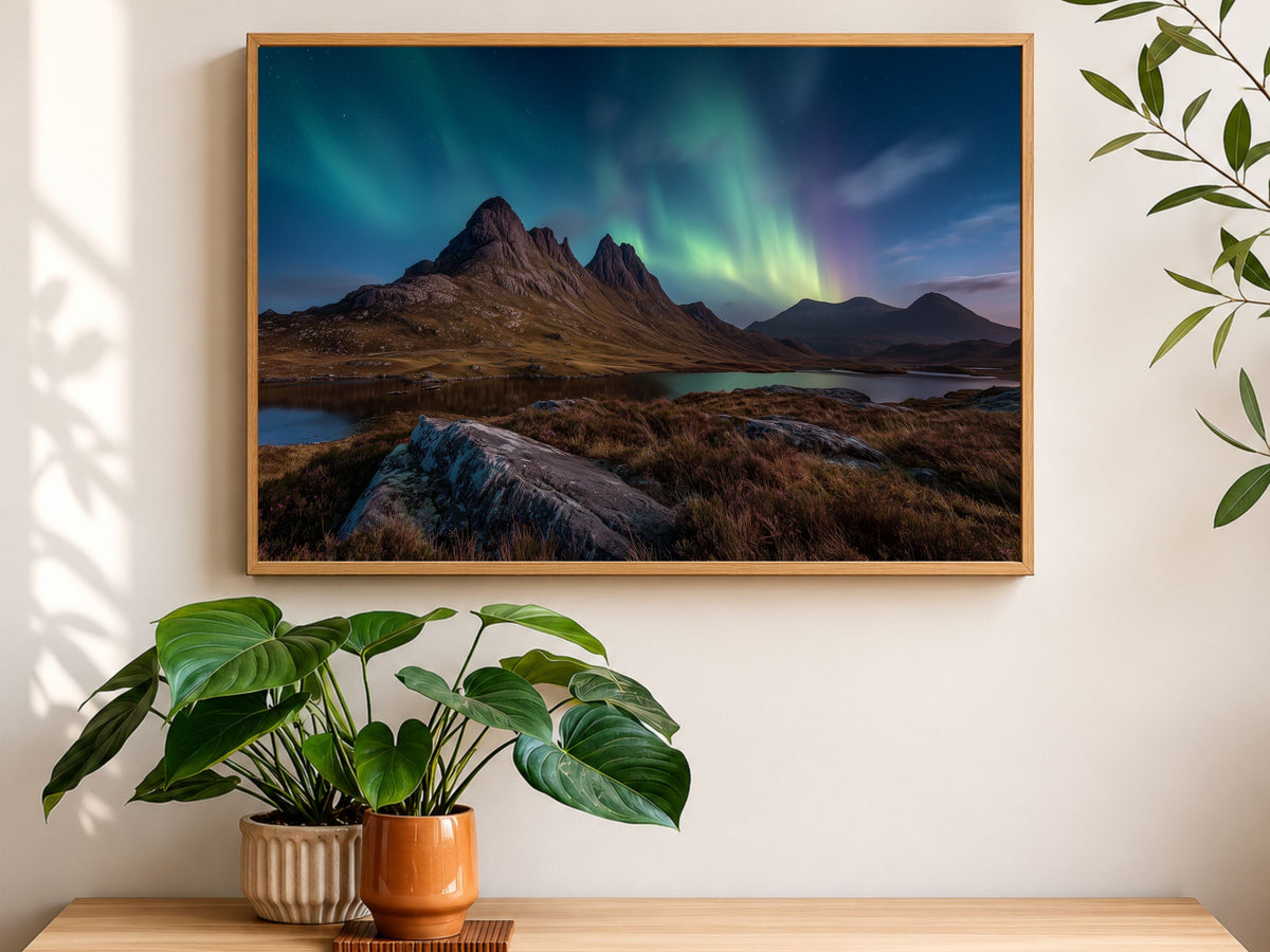 Northern lights over a Highland loch and mountain, framed in light wood above a sideboard in a sunlit room