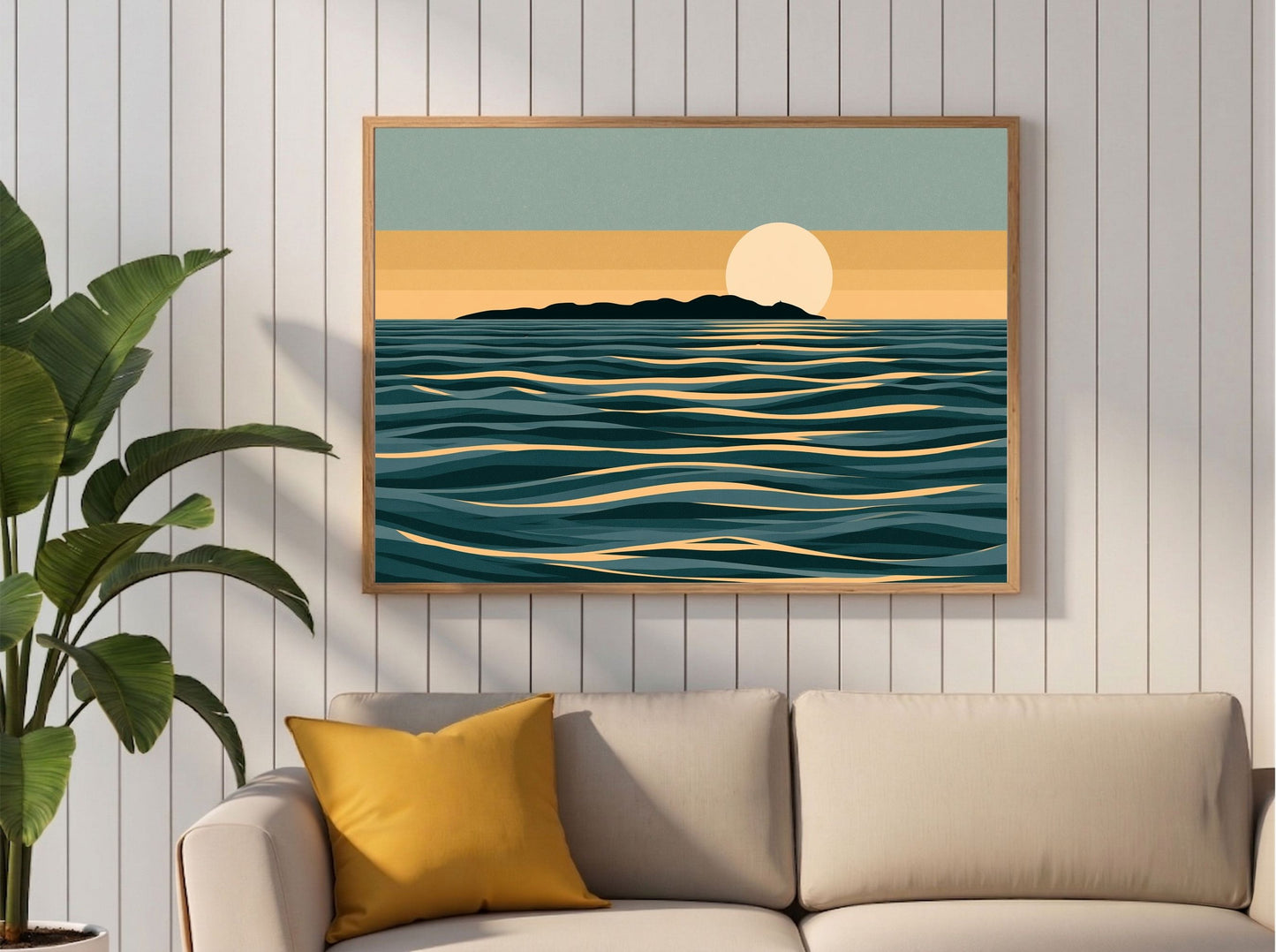 Minimalist moon and sea print in teal and gold, framed in light wood above a cream sofa with a mustard cushion