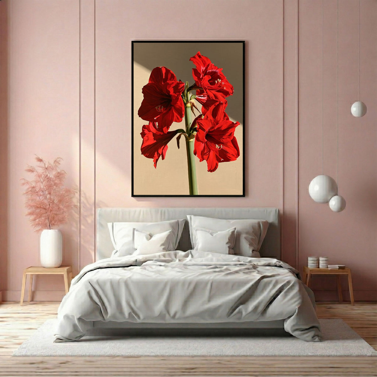 Red amaryllis in full flower, in a black frame above a bed with white linen in a soft pink panelled bedroom