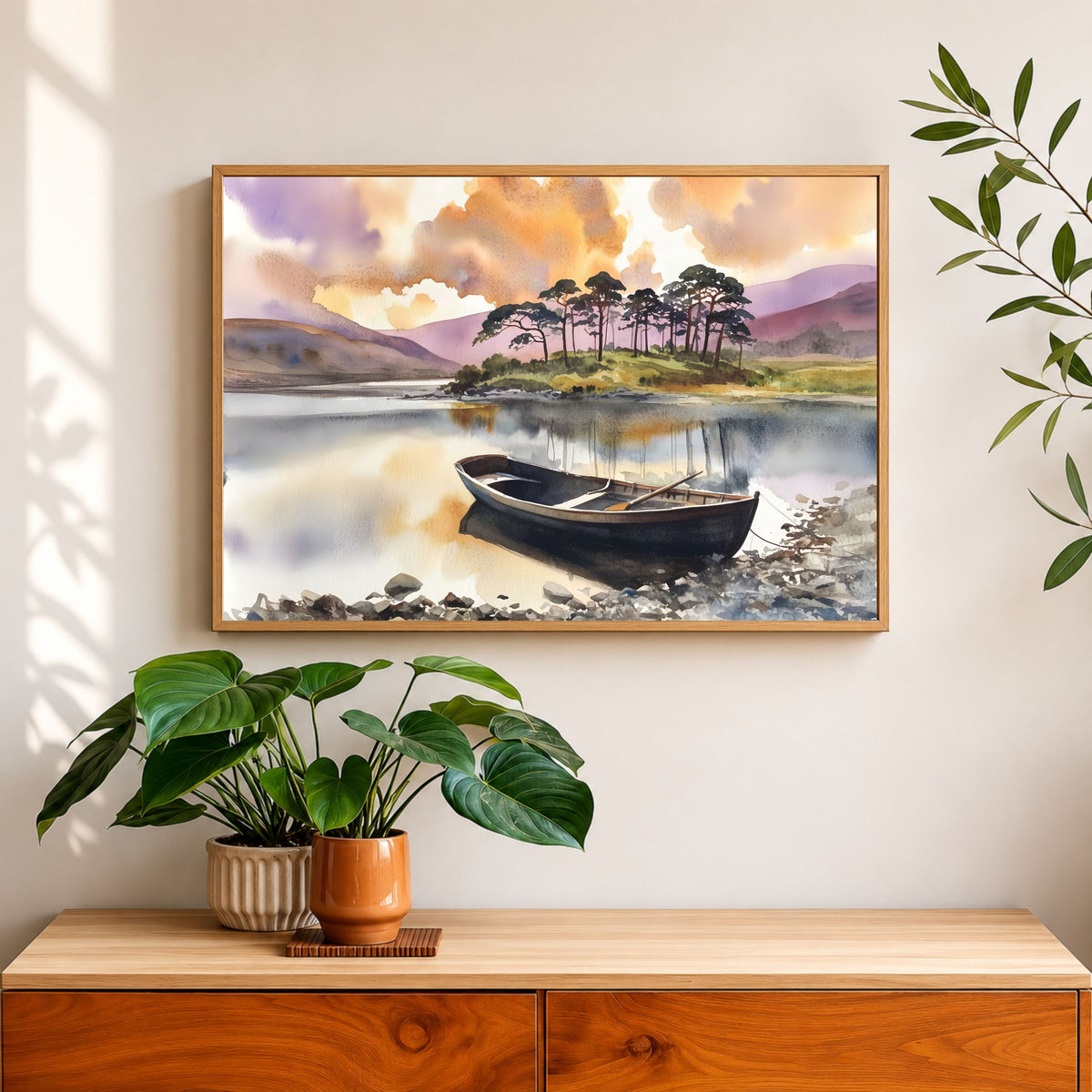 Rowing Boat on the Loch, in a natural wood frame above a wooden sideboard with potted plants against a warm white wall
