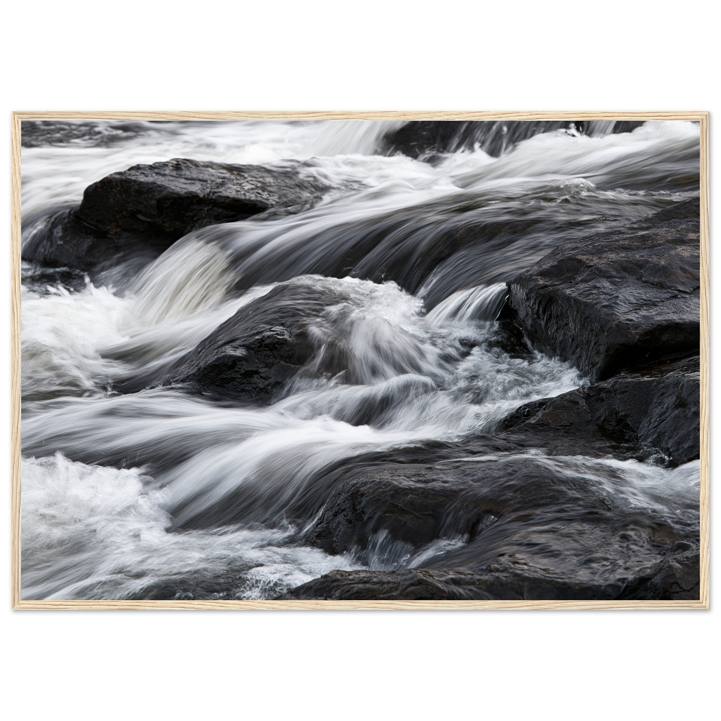 Silk water over dark rock, print in a natural wood frame