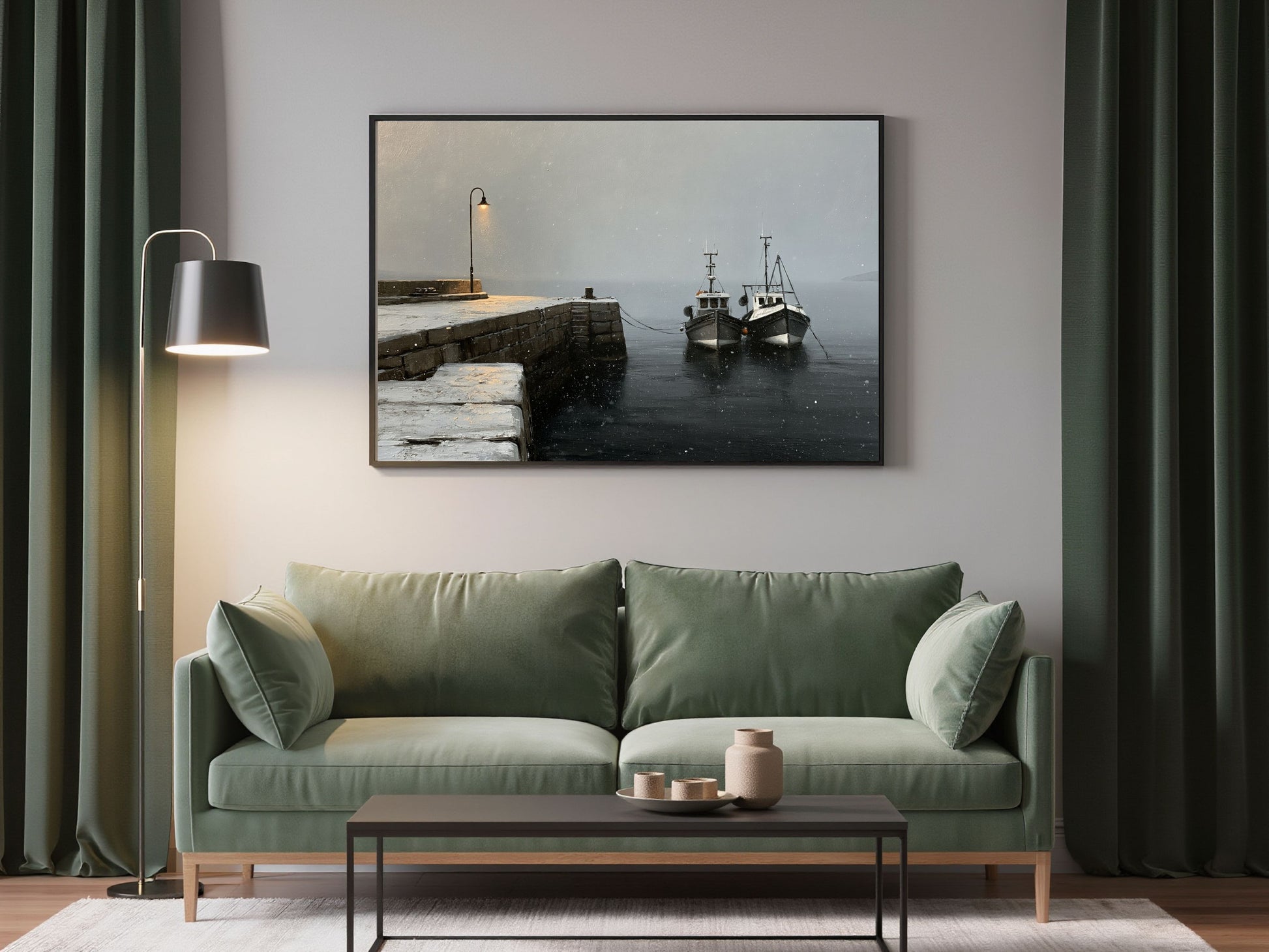 Winter harbour print in a dark frame above a green sofa in a living room