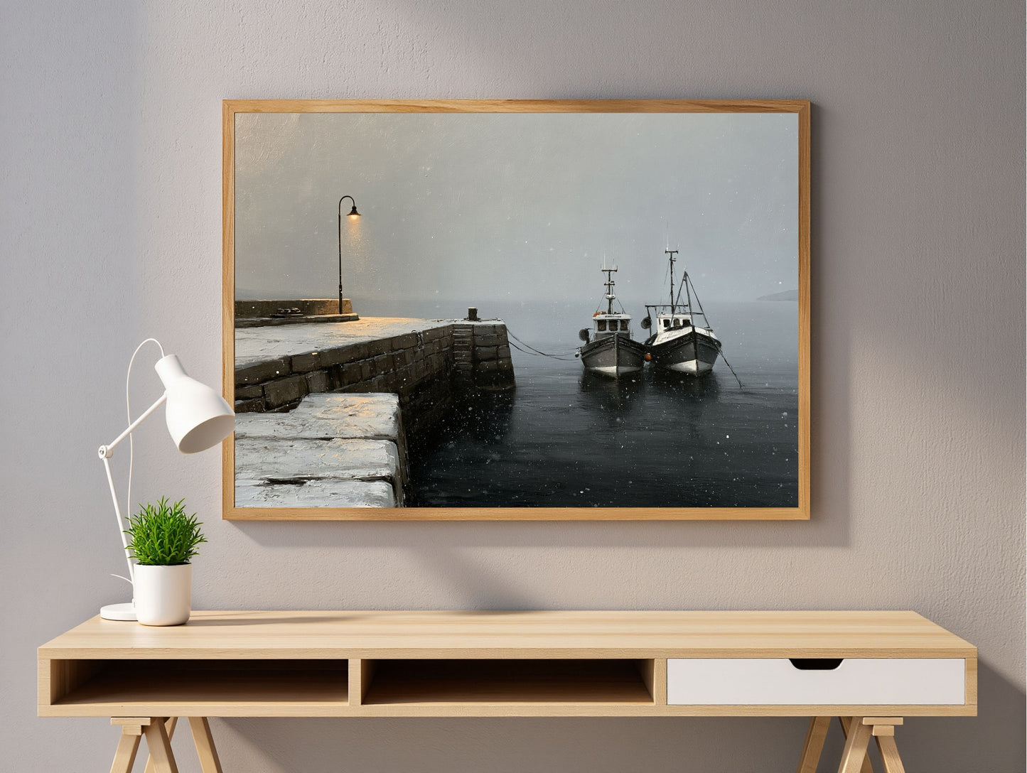 Winter harbour print in a wood frame above a wall-mounted desk in a light study