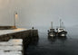 Two fishing boats moored against a snow-covered stone pier in falling snow
