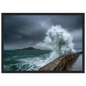 Storm wave bursting over a stone sea wall, print in a black frame