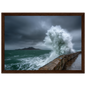 Storm wave bursting over a stone sea wall, print in a dark brown wood frame
