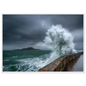 Storm wave bursting over a stone sea wall, print in a white frame