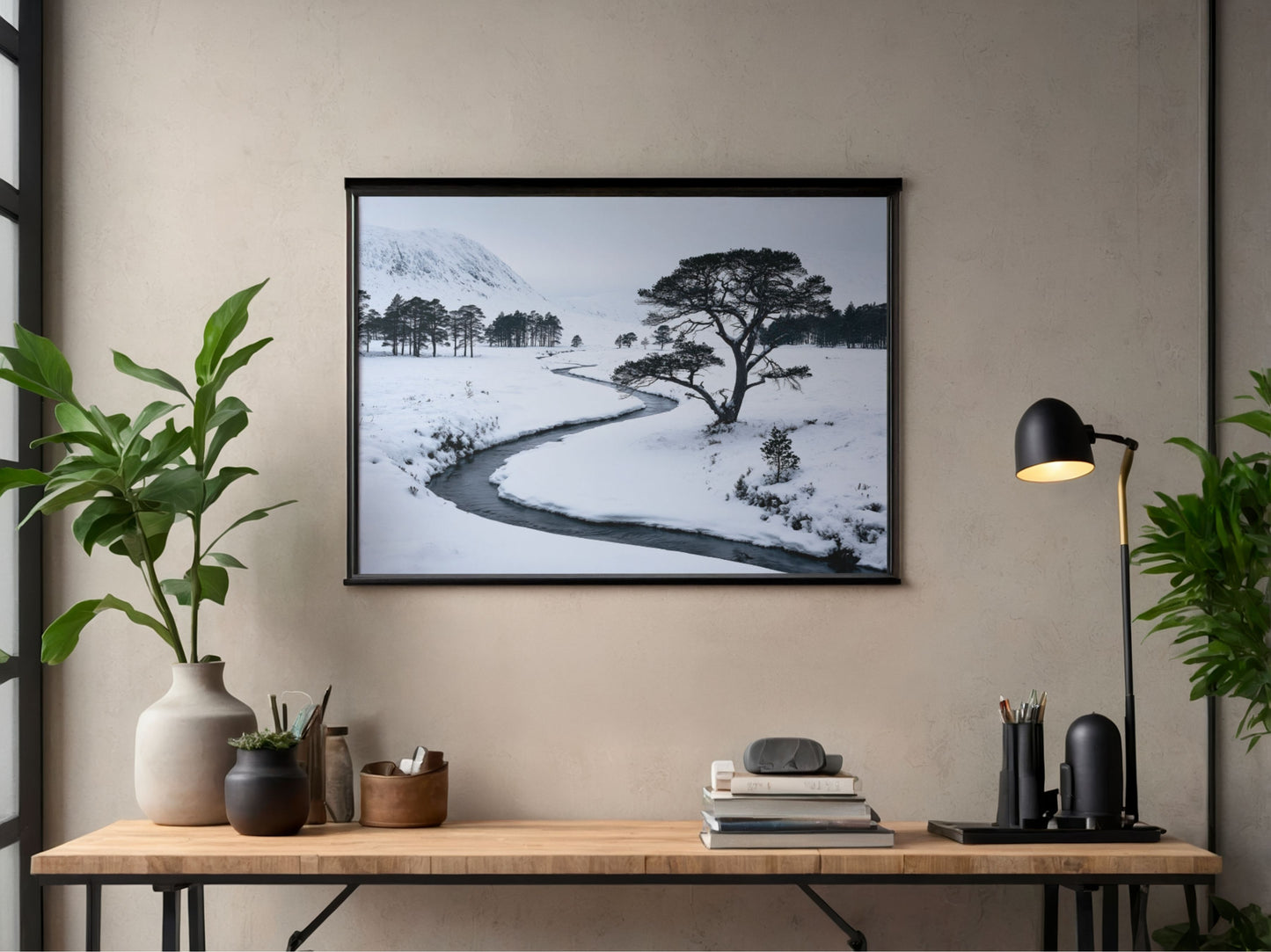 Frozen burn print in a black frame above a slim desk in a modern home office