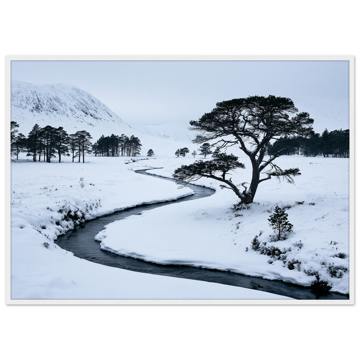 A snow-filled Highland glen with a frozen burn, print in a white frame