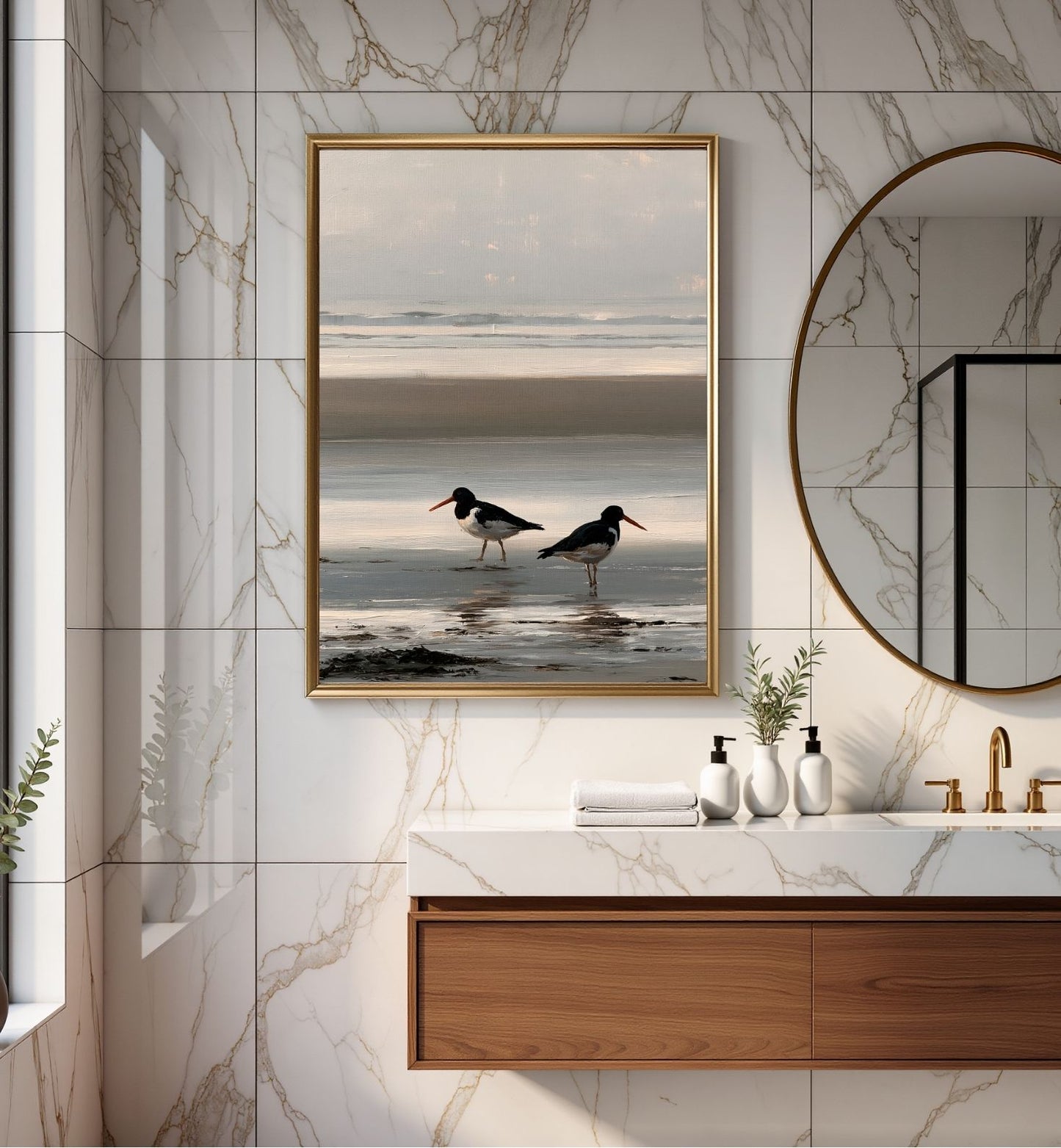 Two oystercatchers at low water, framed in gold above a marble vanity in a modern bathroom