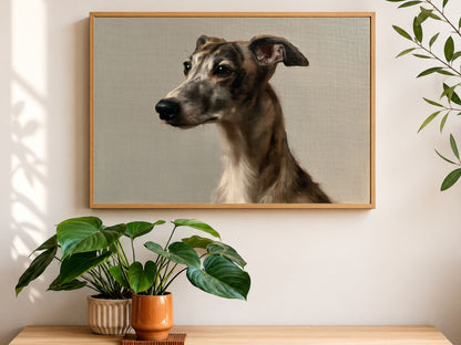 A brindle whippet oil portrait in a wood frame, hanging above a console table with houseplants
