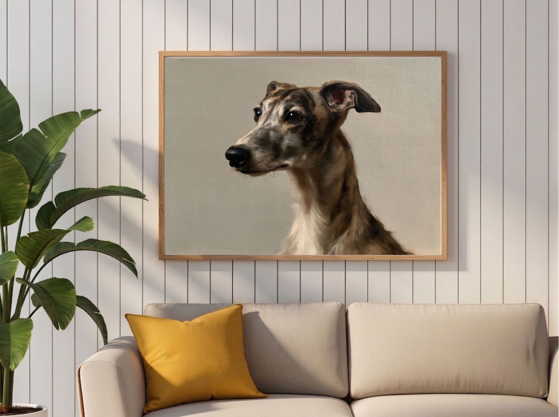 A brindle whippet oil portrait hanging above a cream sofa in a panelled living room