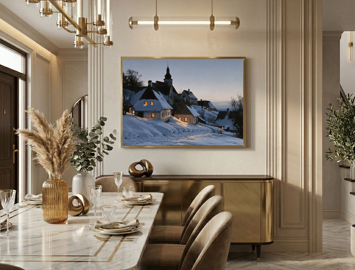 Snowy village at dusk print in a gold frame above a marble dining table in an elegant dining room