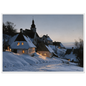 A snow-covered village with lit windows at dusk, print in a white frame